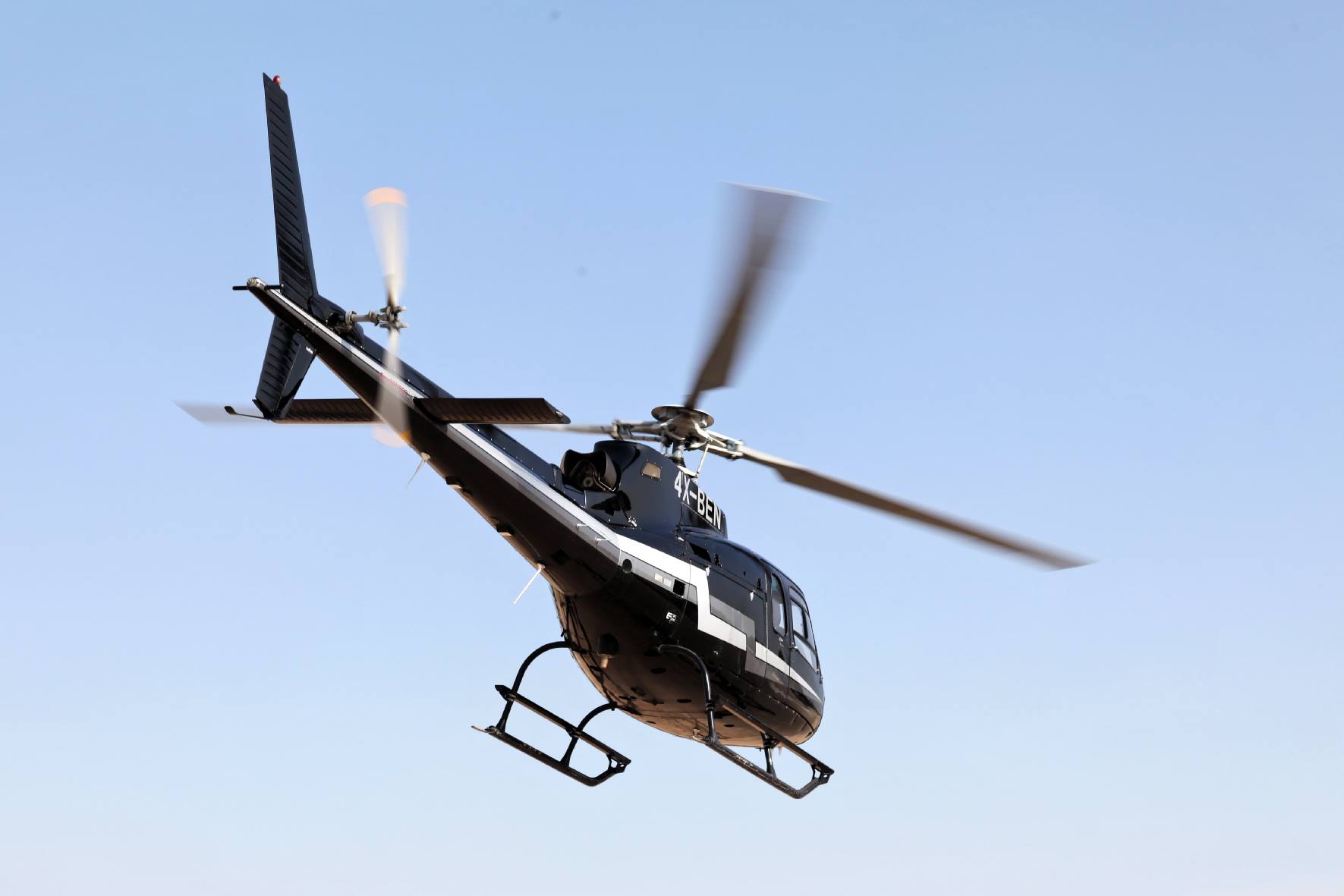 TLV Helicopters black helicopter in flight over Israel