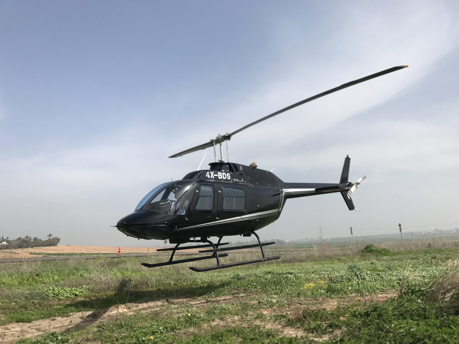 Helicopter over green fields